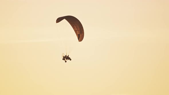 Tandem Paramotor Gliding - Two Men Flying and Gliding in the Air alt