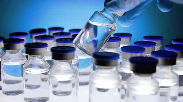 Group of Vaccine bottles. Medicine in ampoules. Glass vials for liquid samples in laboratory. alt