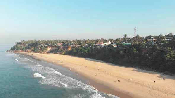 Varkala Beach, unique palm-covered red cliffs. Paradisiac sand beach, Kerala, India alt