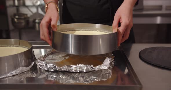 The Confectioner Takes The Cake Out Of The Mold And Puts It On The Board To Pour The Caramel