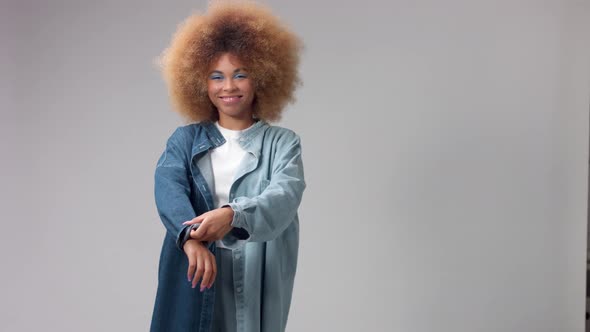 Mixed Race Black Woman with Big Afro Hair in Studio Alone Wears a Denim Shirt