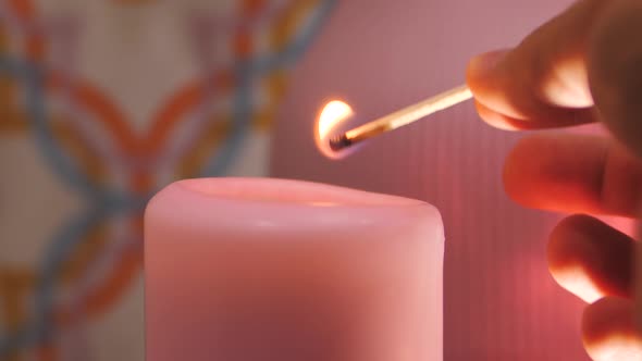 Man's Hand Lighting Christmas Candles alt