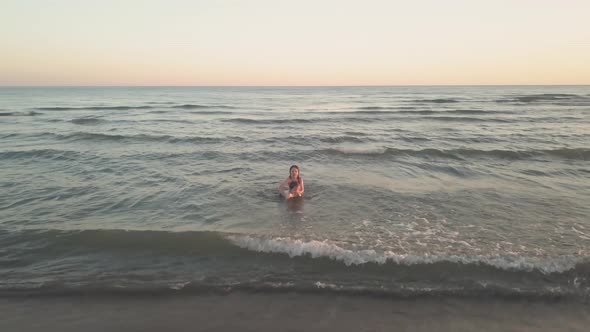 Young Sister and Brother Who Are Playing in the Sea