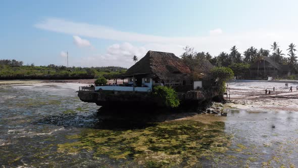The Rock Restaurant in Ocean Built on Cliff at Low Tide on Zanzibar Aerial View alt