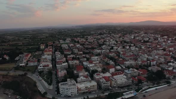  - Flying Over the Houses Rooftops in Coastal Town, Sunrise Scene. Nea Kallikratia, Greece alt
