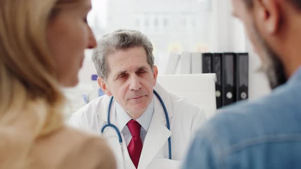 Mature doctor consulting prognosis with patients. Shot with RED helium camera in 8K  alt