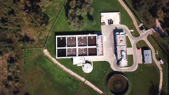 Aerial top down view flying over wastewater treatment plant also known as sewage treatment plant or alt