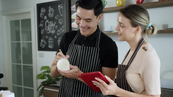 Multi ethinic colleague working together in cafe, reading order, taking note alt