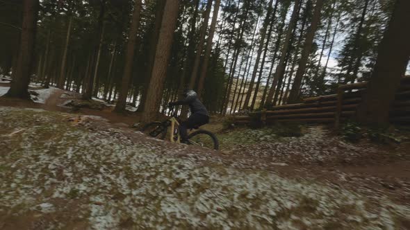 Drone Following Cyclist N Dirt Track In Winter Forest alt