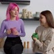 Cheerful Lovely Female Roommates Chatting Over Coffee in Kitchen at Dorm - VideoHive Item for Sale