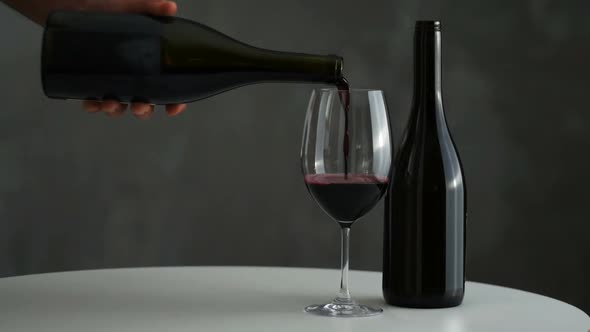 Red Wine Pouring Into Wine Glass. Close Up alt