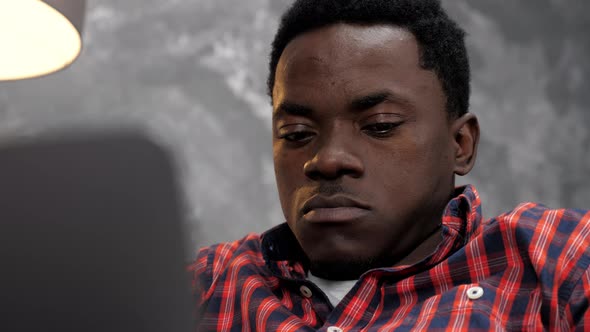 African American Businessman Works Laptop Online Chatting with Company Employees alt