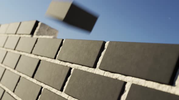 The clinker brick wall being build at clear blue sky background. Loopable alt