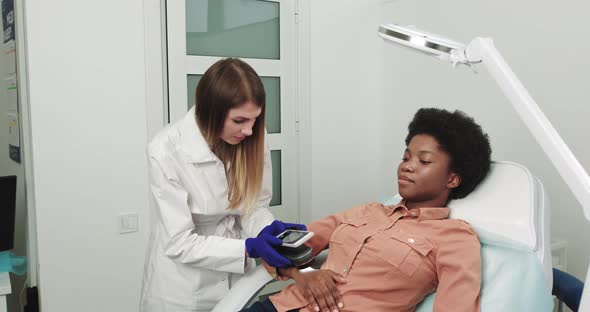 Professional Doctor The Dermatologist Research A Birthmark On The Phone alt