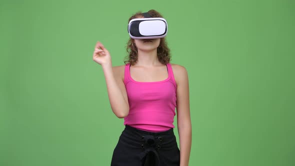 Young Beautiful Woman with Curly Blond Hair Using Virtual Reality Headset alt