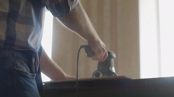 Carpenter Uses a Grinding Machine to Align