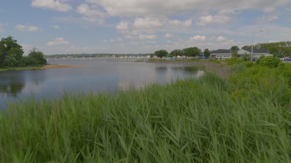Flying Over Long Green Grass and Towards Manhasset Bay in Port Washington alt