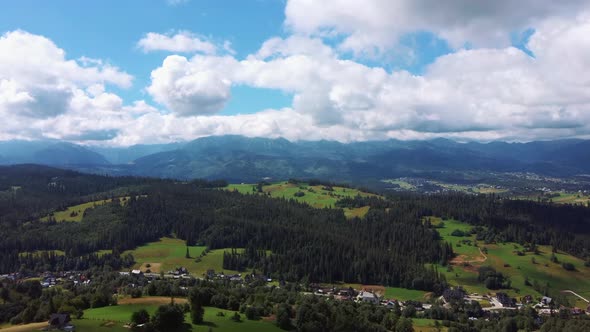 Flight Over a Mountain Cottage Village in Poland, Zakopany, Tatra National Park Aerial 4K Video alt