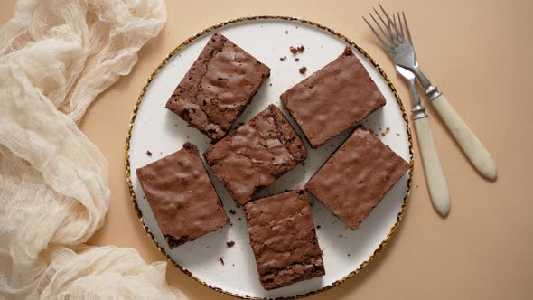 Delicious Homemade Chocolate Brownies Served on White Plate Over Beige Background