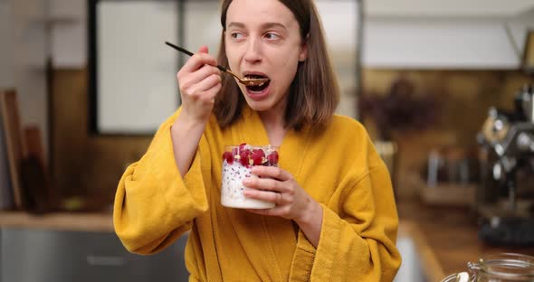 Hungry Woman Having a Breakfast at Home alt