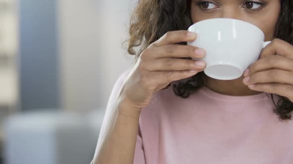 Biracial girl drinking tea and refusing sweet cake, dieting and healthcare alt