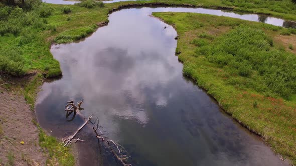 Looking down while slowly flying over river alt