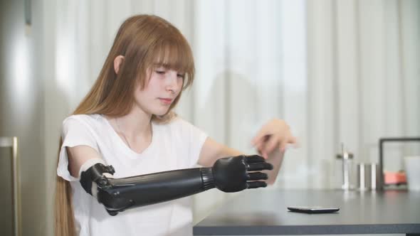 Disabled Girl Checking Her Metal Prosthetic Arm