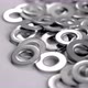 Pile of shiny round metallic fastening washers on a white background. Metal steel chromed spacers - VideoHive Item for Sale