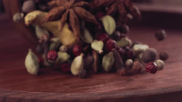 Spices are Poured From the Bowl on a Wooden Table alt