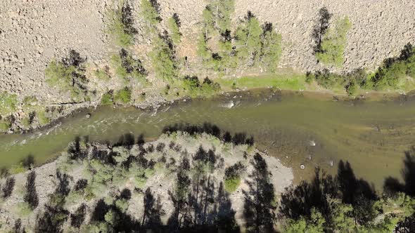 Broken Crumbled Rocks Spilling From the Narrow Canyon Slope Ridge Towards the Deep Valley Floor alt