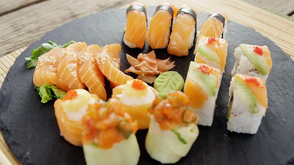 Close-up of various sushi on tray with chopstick alt