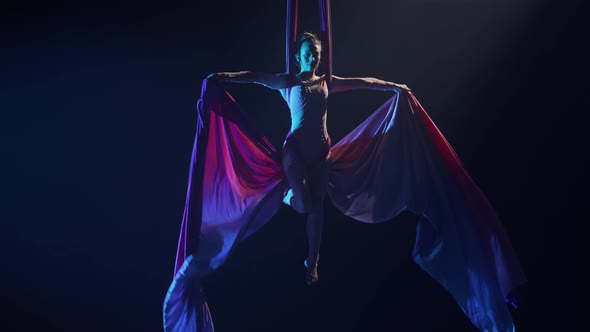Equilibrium Gymnast Rotating on Airy Silk and Demonstrates Grace of Movement alt
