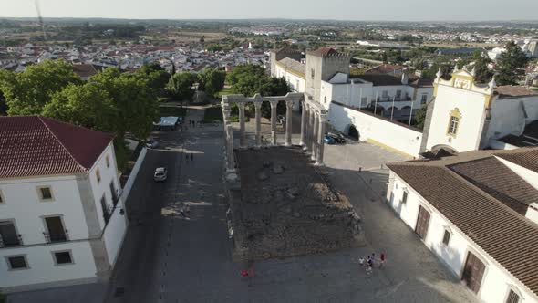 People walking by ruins of Temple of Diana, Evora. Aerial shot