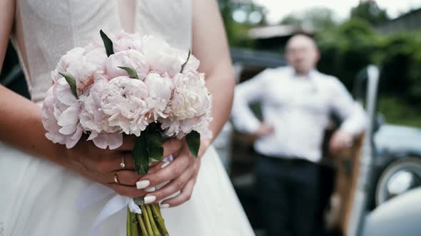 Wedding Bouquet in the Hands of a Beautiful Bride The Bride Holds a Wedding Bouquet of Flowers alt