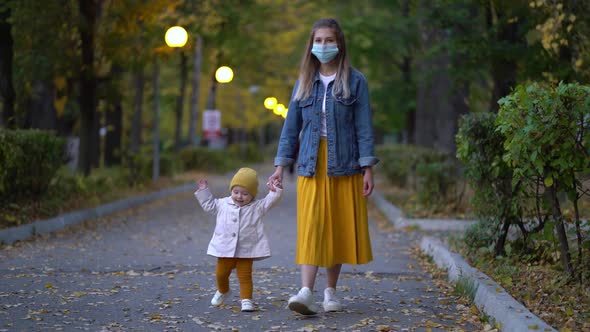 Masked Mother Holds Hand Lovely Daughter on Street Walk During Second Wave Quarantine Coronavirus alt