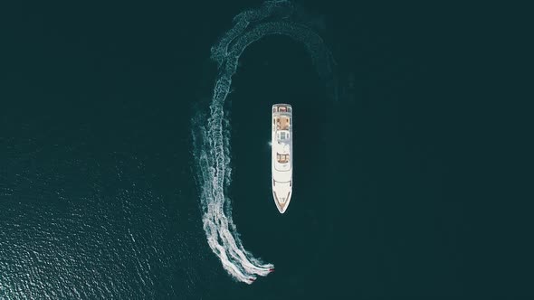 Top-down view of two jet-ski moving parallel to the large yacht. Super yacht alt