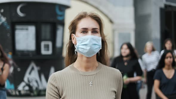 Beautiful Woman Mask Walk Crowded Street Coronavirus. Urban Life People Covid-19 alt