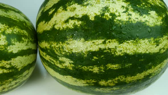 Two Watermelons Covered With Water Drops