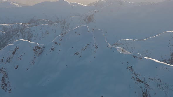 Aerial View From an Airplane of Beautiful Snowy Canadian Mountain Landscape alt