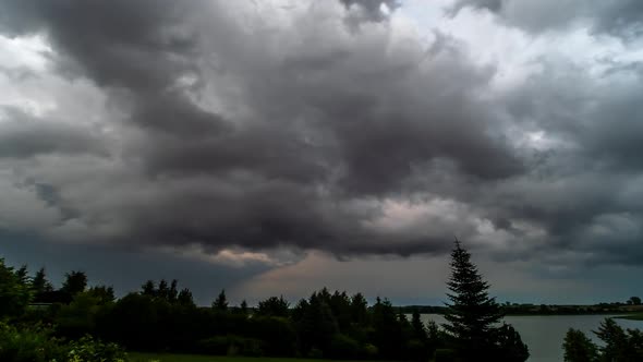 Storm Clouds Over Trees And Lake 