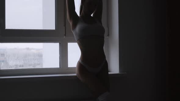 Woman in White Lingerie Showing Body Shapes