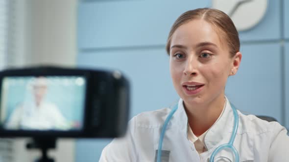 Young woman blogger in white medical coat alt