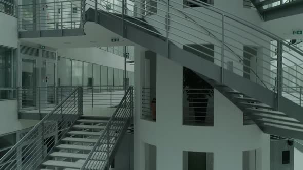 Stairs inside a modern generic white building Camera rising ascending Hi key white