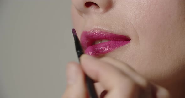 Young Woman Having Lipstick Applied With A Brush