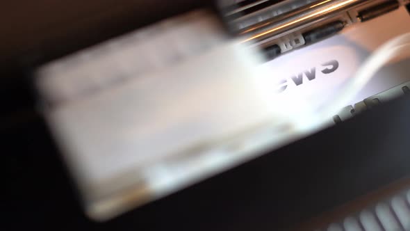 Printer Prints the Words World News on White Glossy Paper alt