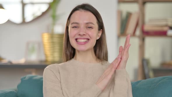 Portrait of Positive Young Woman Clapping at Home alt