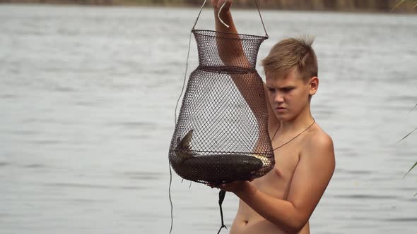 The Teenager Examines the Caught Fish