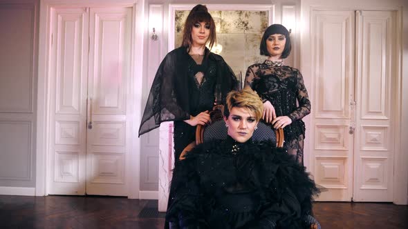 Queen transvestites sit throne transgenders lesbians women. People look camera. alt