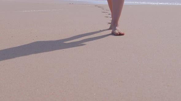 Woman Walking on Beach alt