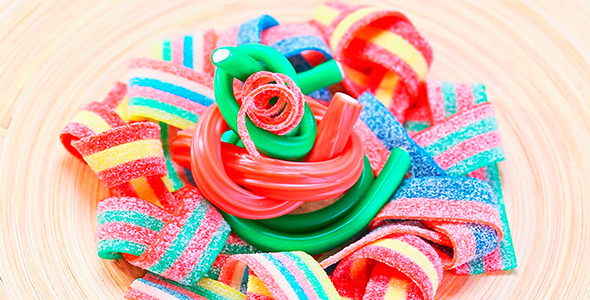 Colorful Gummy Candy Rotating On Wooden Plate